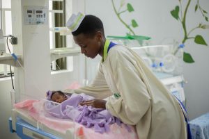 Nurse caring for a newborn in hospital, illustrating trust between parents and nurses in infant care